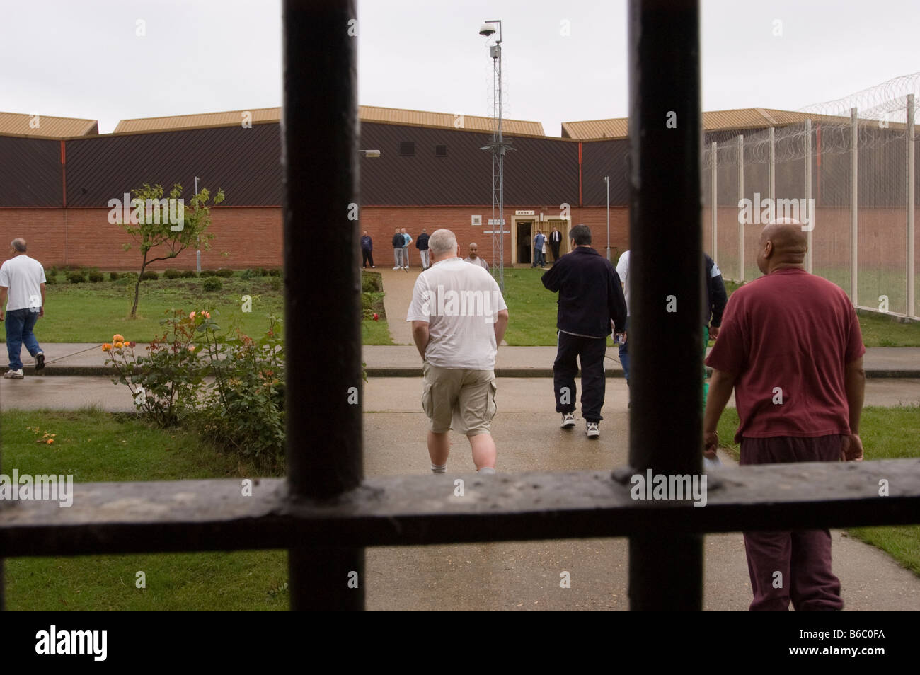 Prisoners walking outside between areas Stock Photo