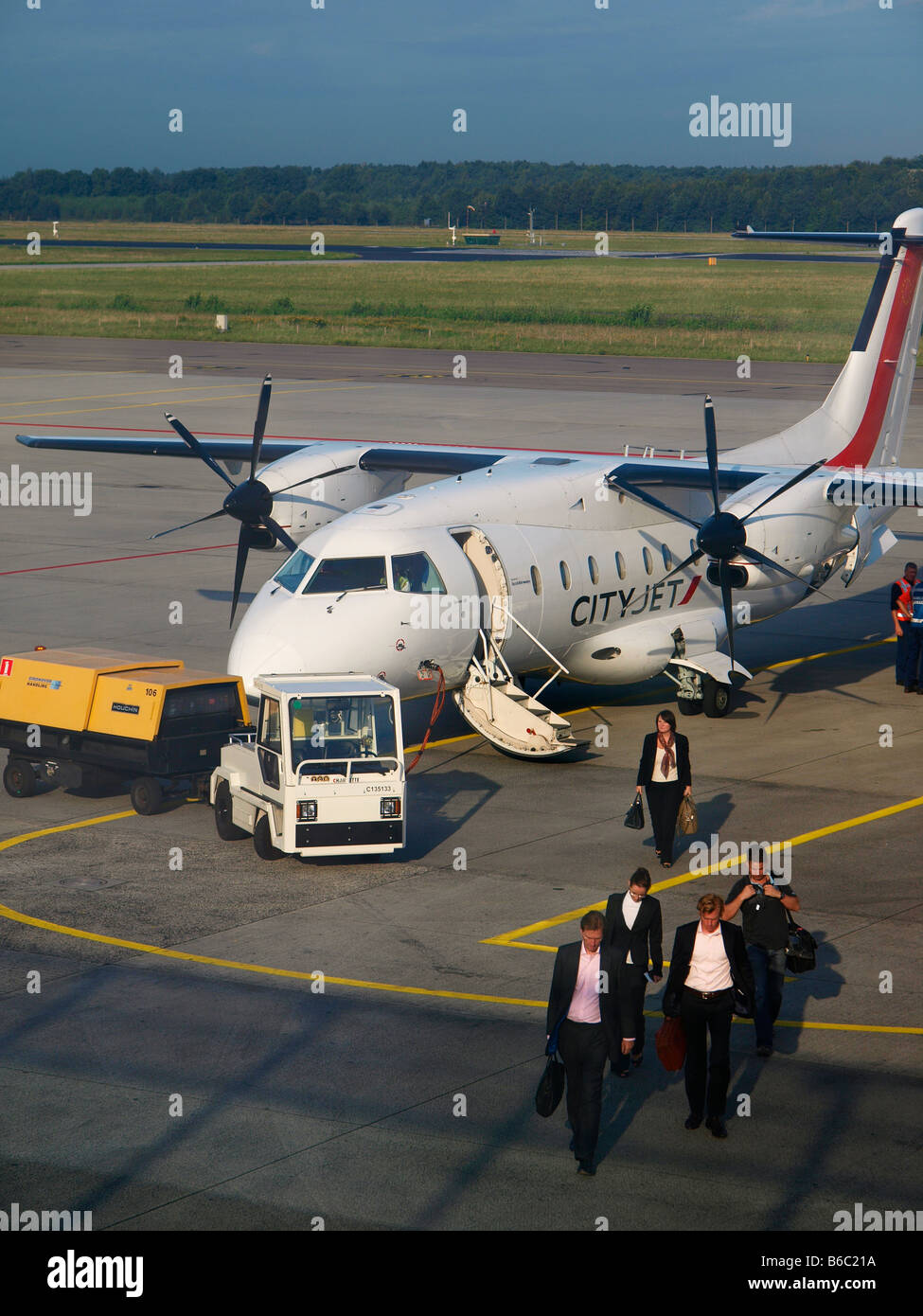 Businesspeople coming from London City Airport exiting a small Dornier 328 aeroplane on Eindhoven Airport Stock Photo