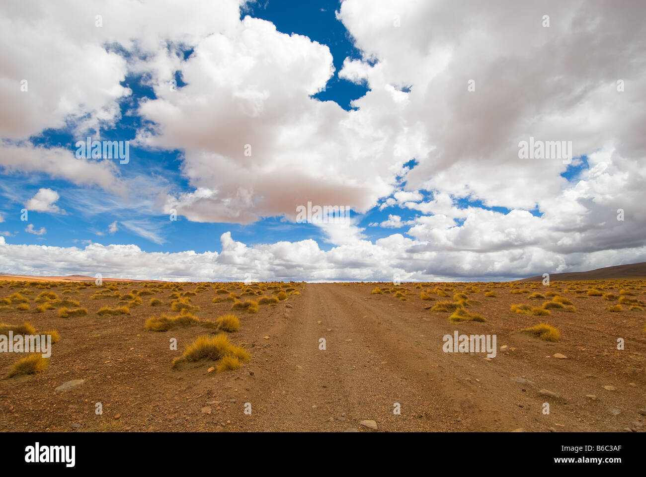 desert road white clouds and deep blue sky Stock Photo - Alamy