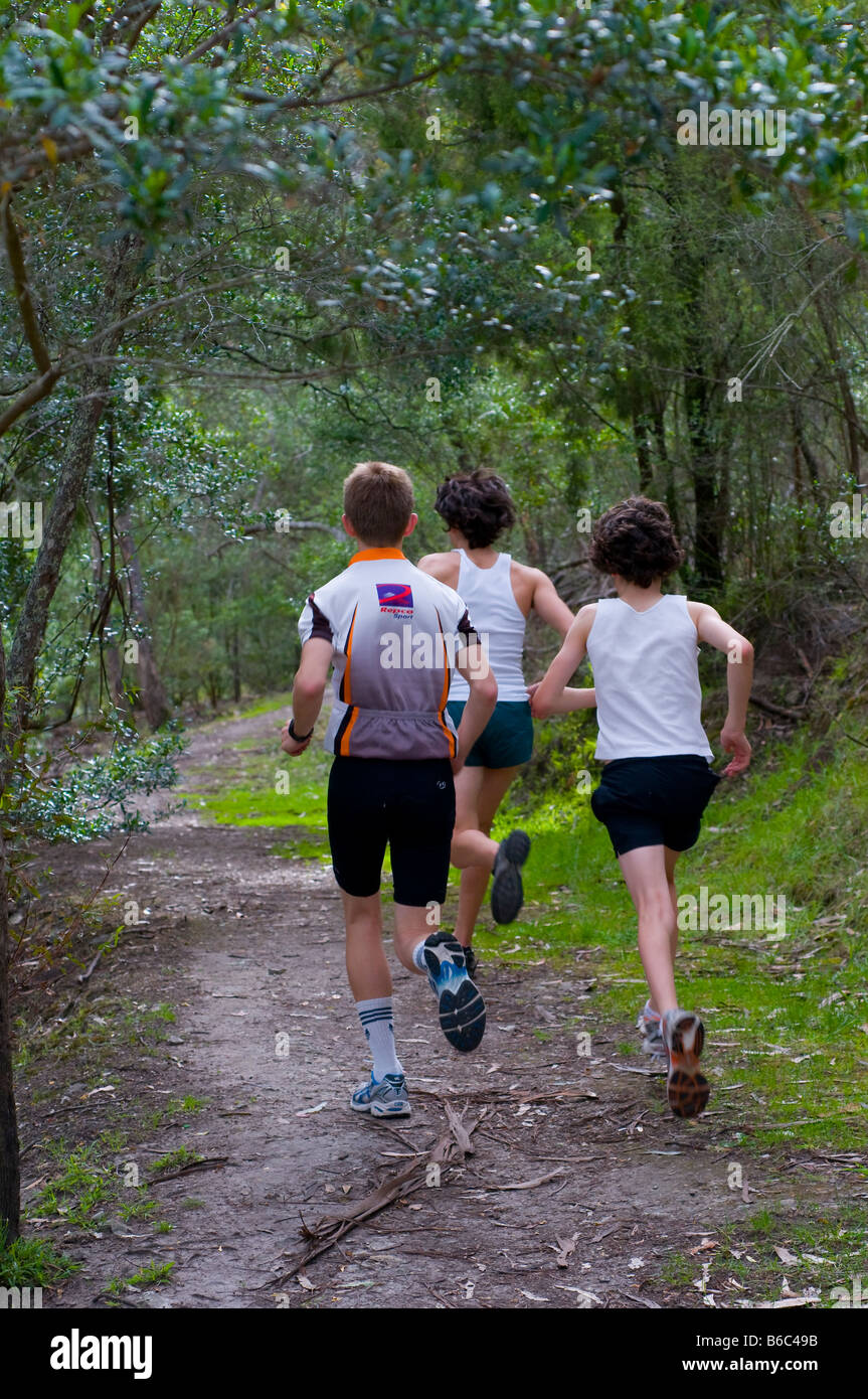 Young boys running on a bush track Stock Photo