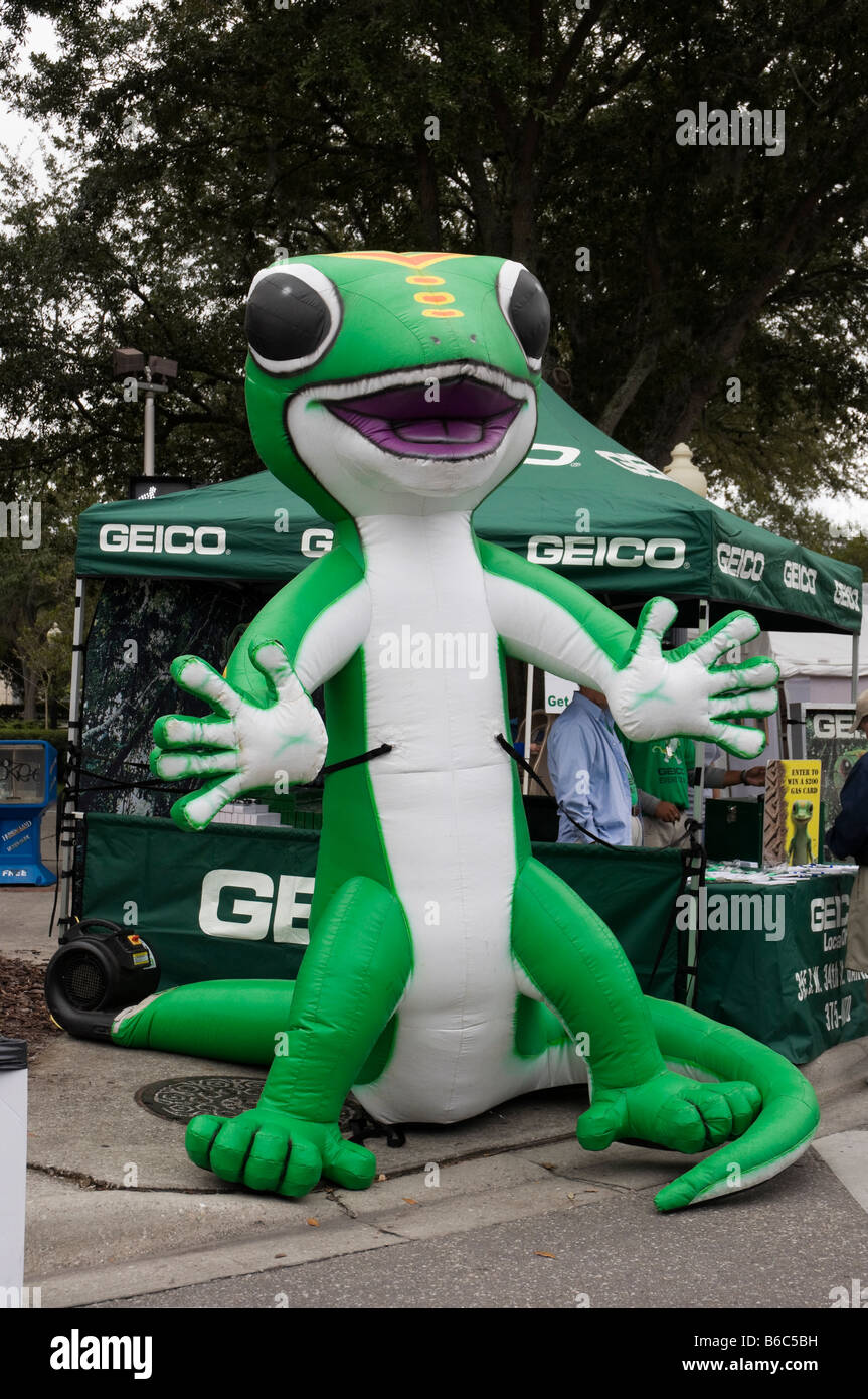 giant inflatable Geico Gekko figure at Geico booth Downtown Arts Festival Gainesville Florida Stock Photo