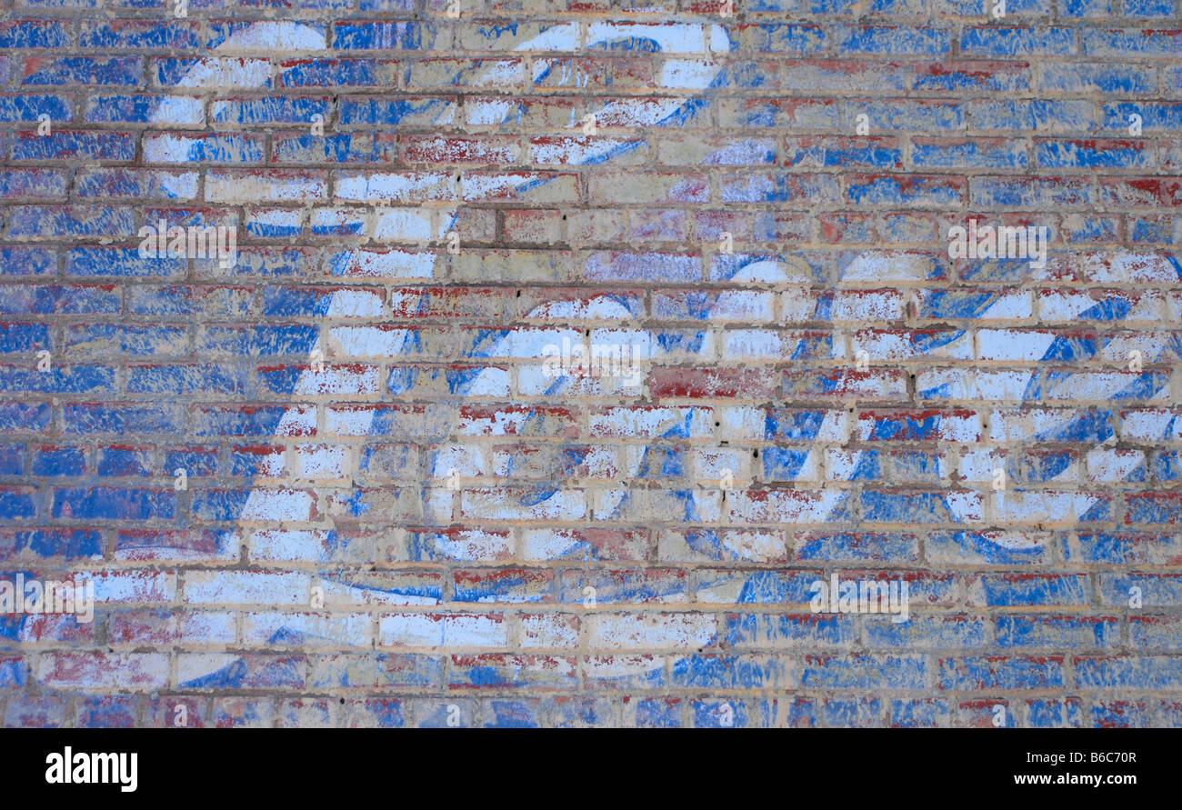 The word LOVE painted in large white script letters on a brick wall Stock Photo