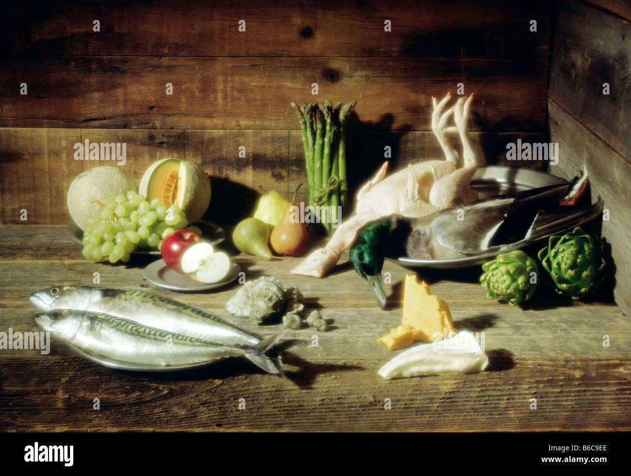 fruits vegetables and meats and shellfish fish on a rustic wooden ...