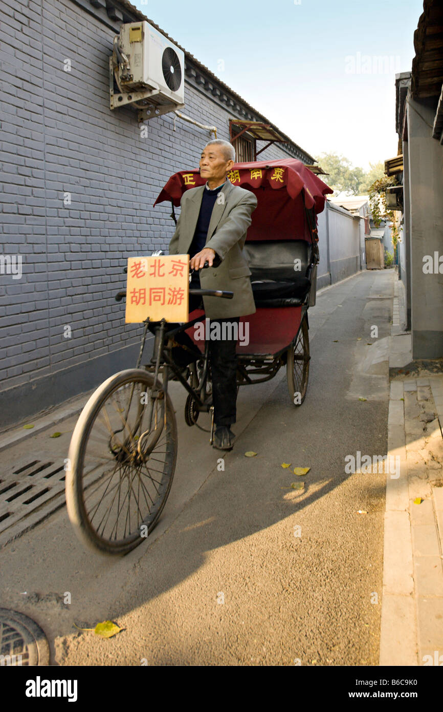 CHINA BEIJING Elderly Chinese rickshaw driver pedals his pedicab ...