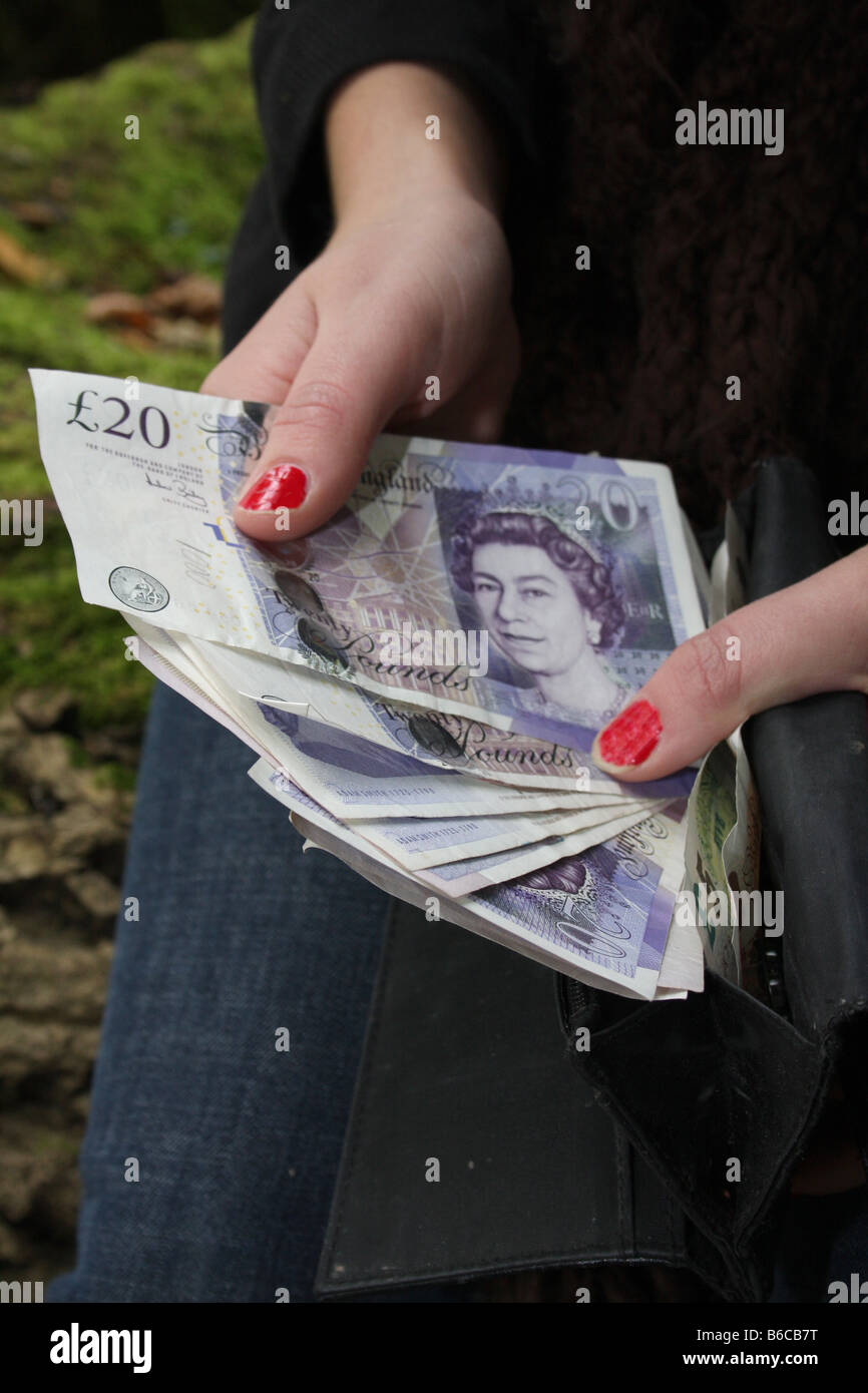A female holding some English sterling Stock Photo - Alamy