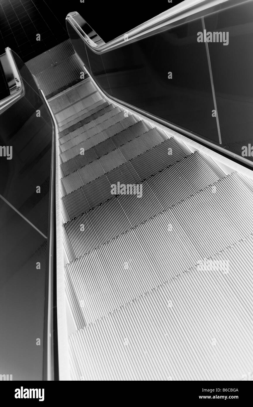 Descending a modern escalator. Stock Photo