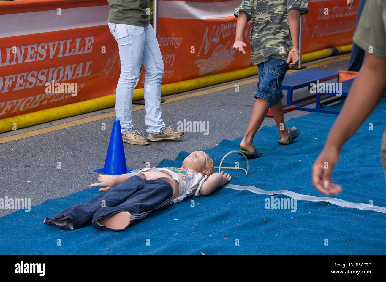 kids at fire department obstacle course with child dummies at Downtown Arts Festival Gainesville Florida Stock Photo