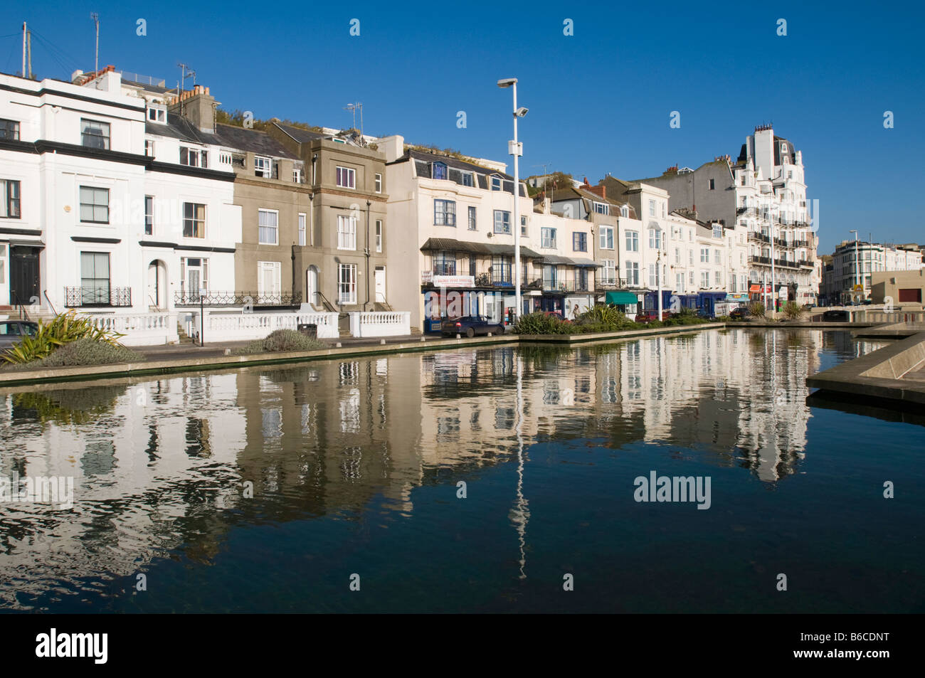 UNITED KINGDOM, ENGLAND, 9th December 2008. Buildings along the seafront at Hastings reflected in a water feature. Stock Photo