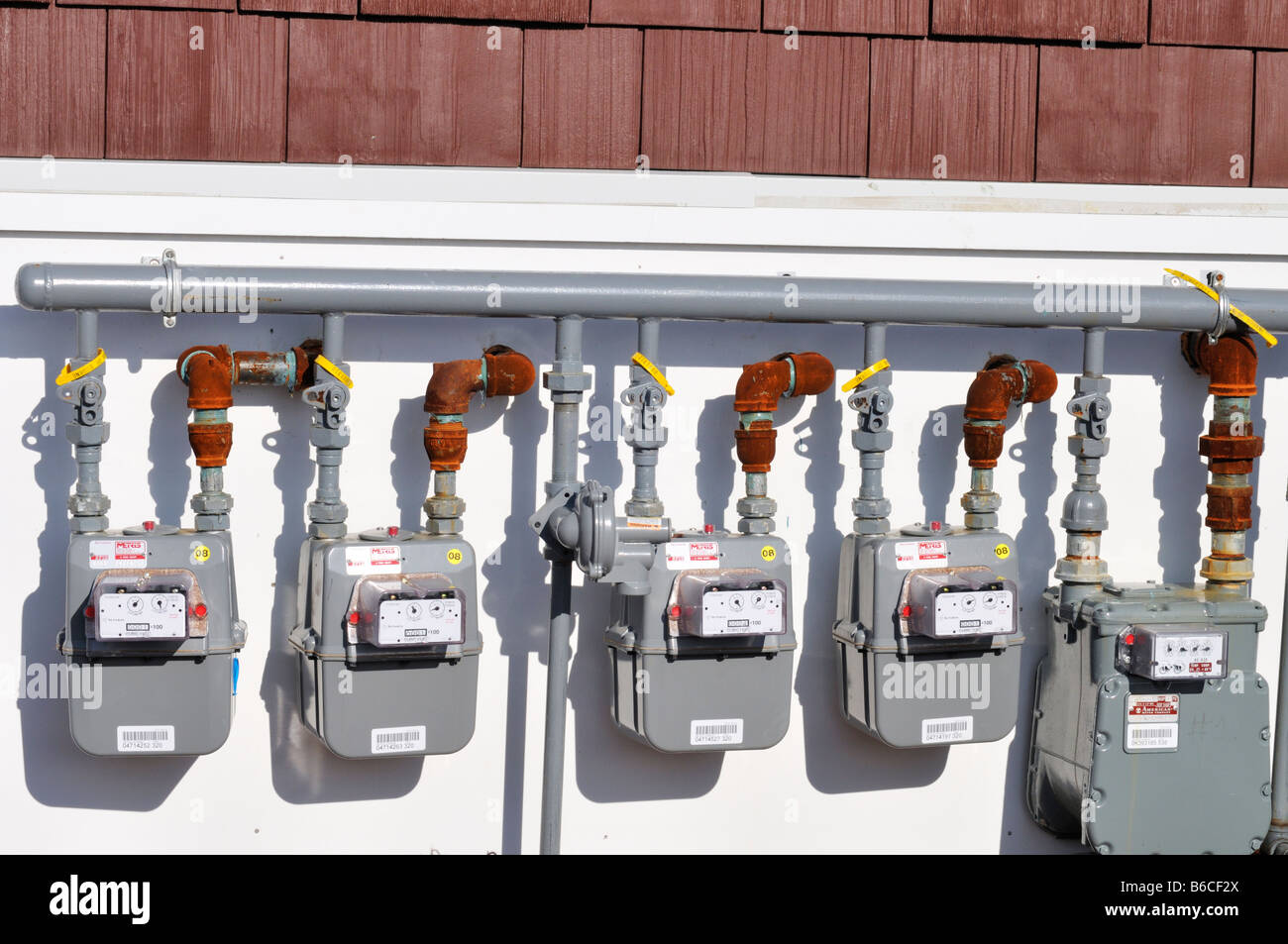 5 Gas Meters mounted on exterior of building USA. Stock Photo