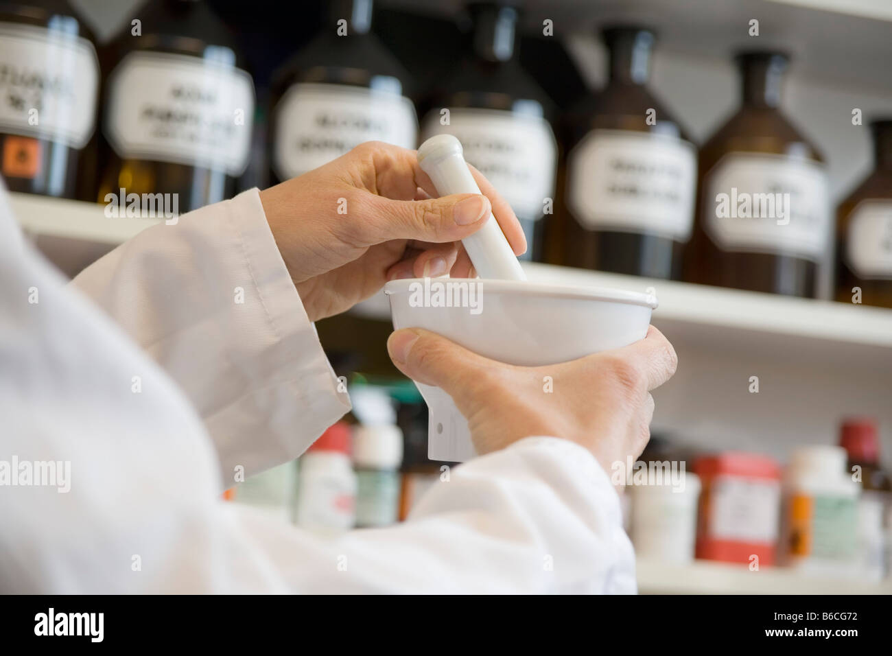 Pharmacist in pharmacy using mortar and pestle Stock Photo Alamy