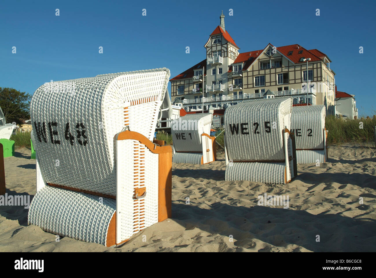 Wicker beach chairs on beach Stock Photo