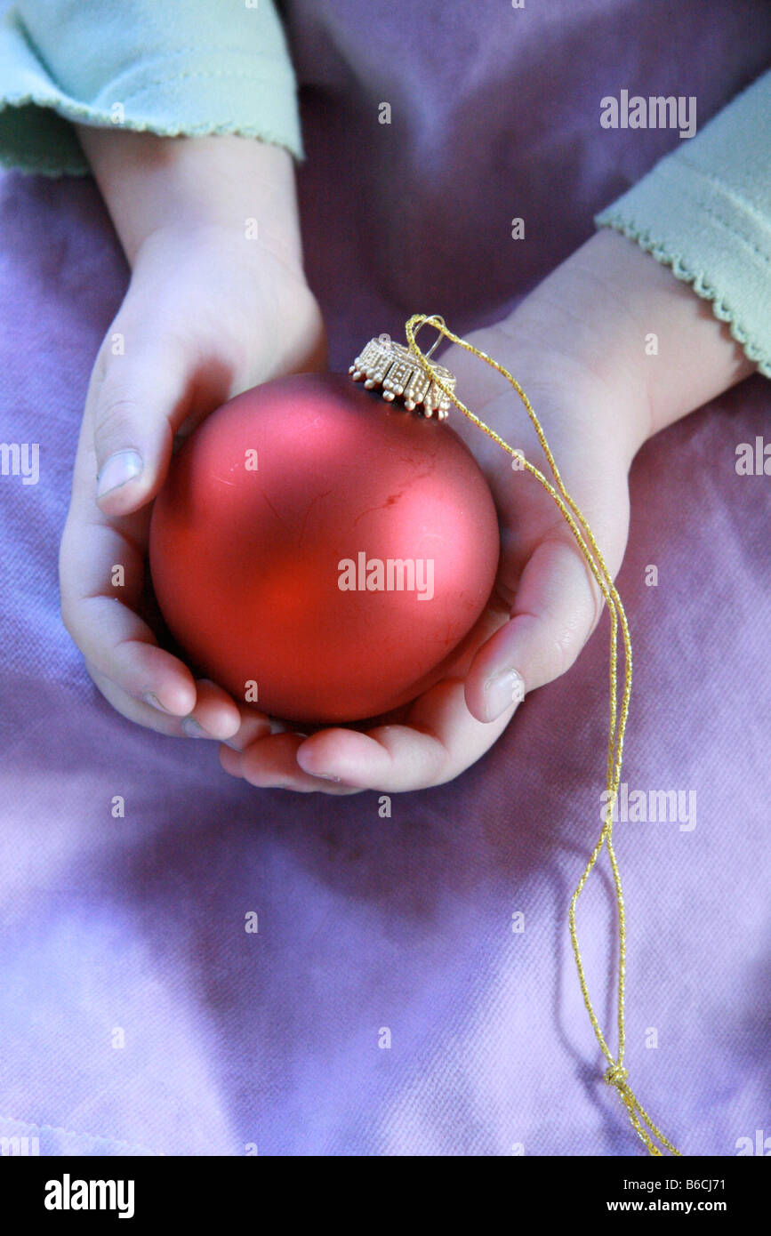 Mid section view of girl holding Christmas bauble Stock Photo