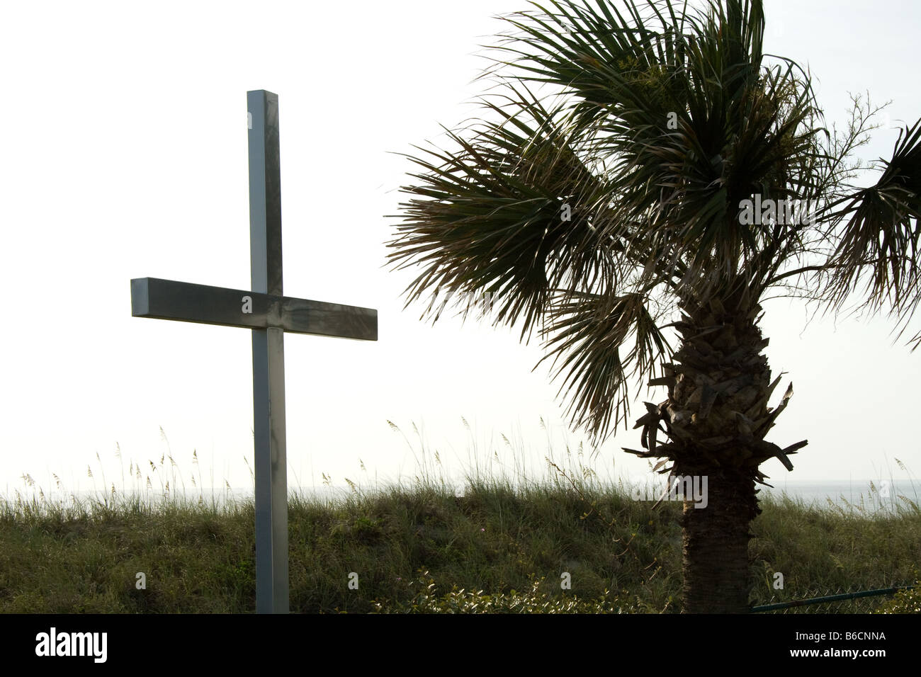 Christian cross by a palm tree in Jacksonville Florida Stock Photo