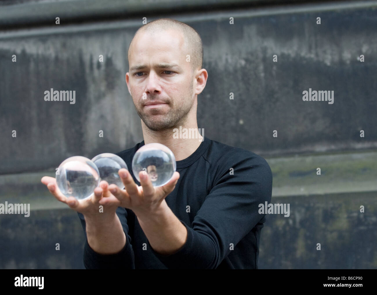 A street artist performing with reflective balls on Edinburgh High Street during the annual