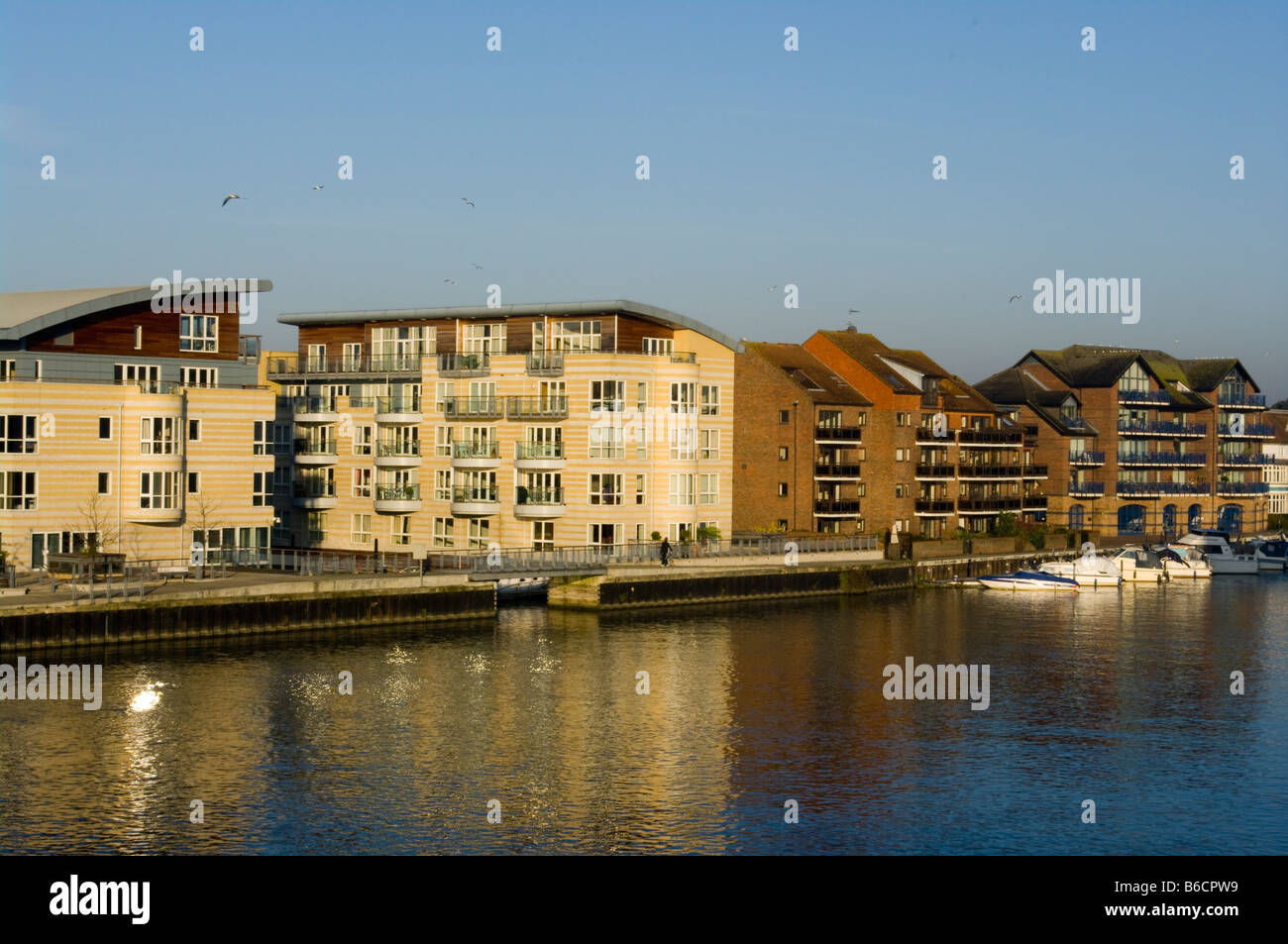 The River Thames By modern Riverside waterfront Apartments Hampton Wick Stock Photo