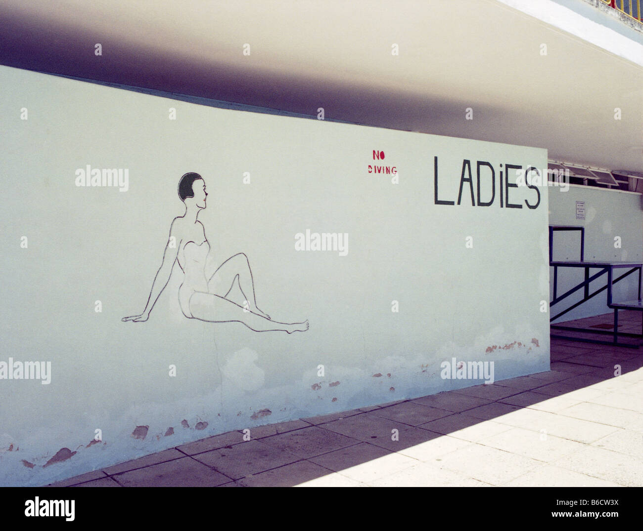 Female figure on wall of changing room at swimming pool, Cape Town, South Africa Stock Photo