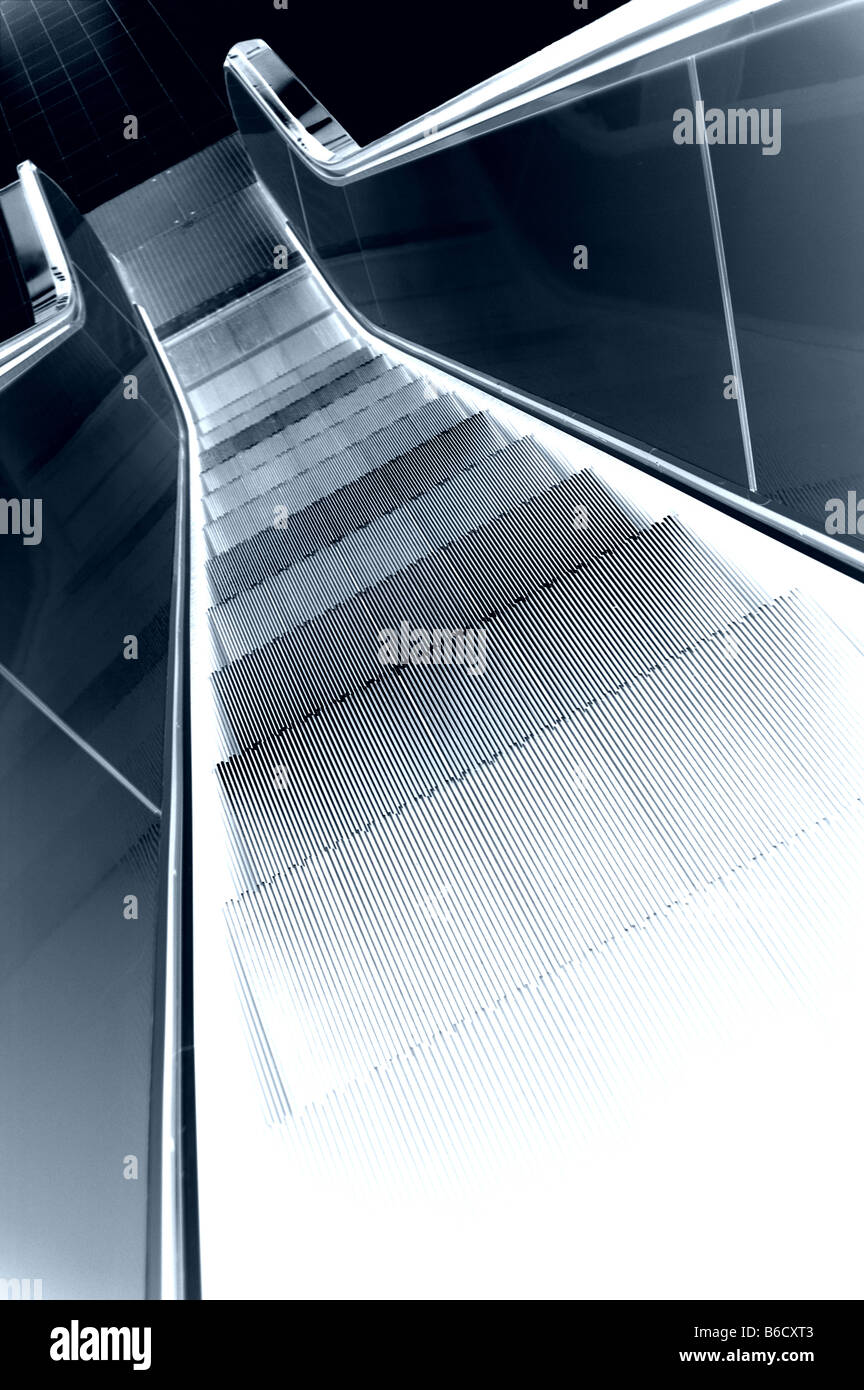 Descending a modern escalator. Stock Photo