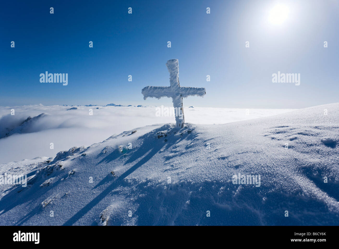 Summit cross covered with snow on mountain, Lungau, Gipfelkreuz, Gloecknerin, Pongau, Salzburg, Austria Stock Photo