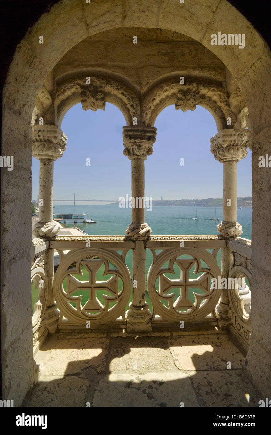Torre de Belém Tower Arches And View Of River Tejo, with the 25th April Bridge In Distance Stock Photo