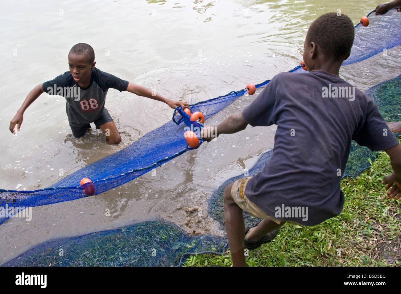 African children working with fishnet, Benin. Stock Photo