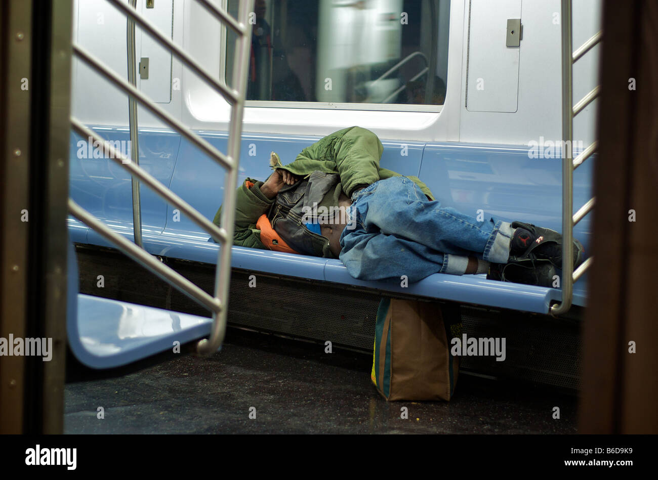 Homeless Man Sleeps in NYC Subway (For Editorial Use Only) Stock Photo