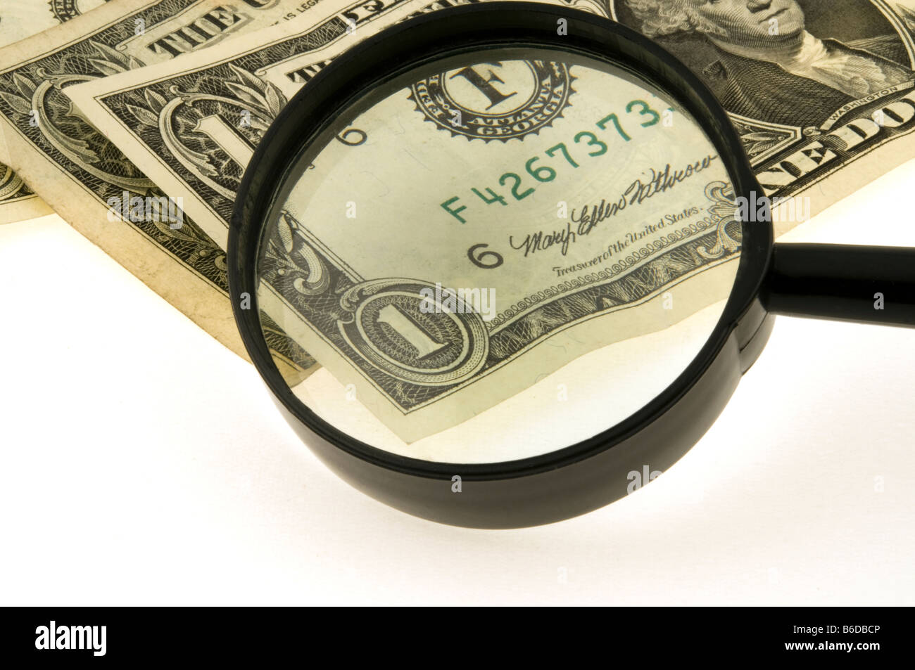 Magnifier increases one dollar Stock Photo Alamy