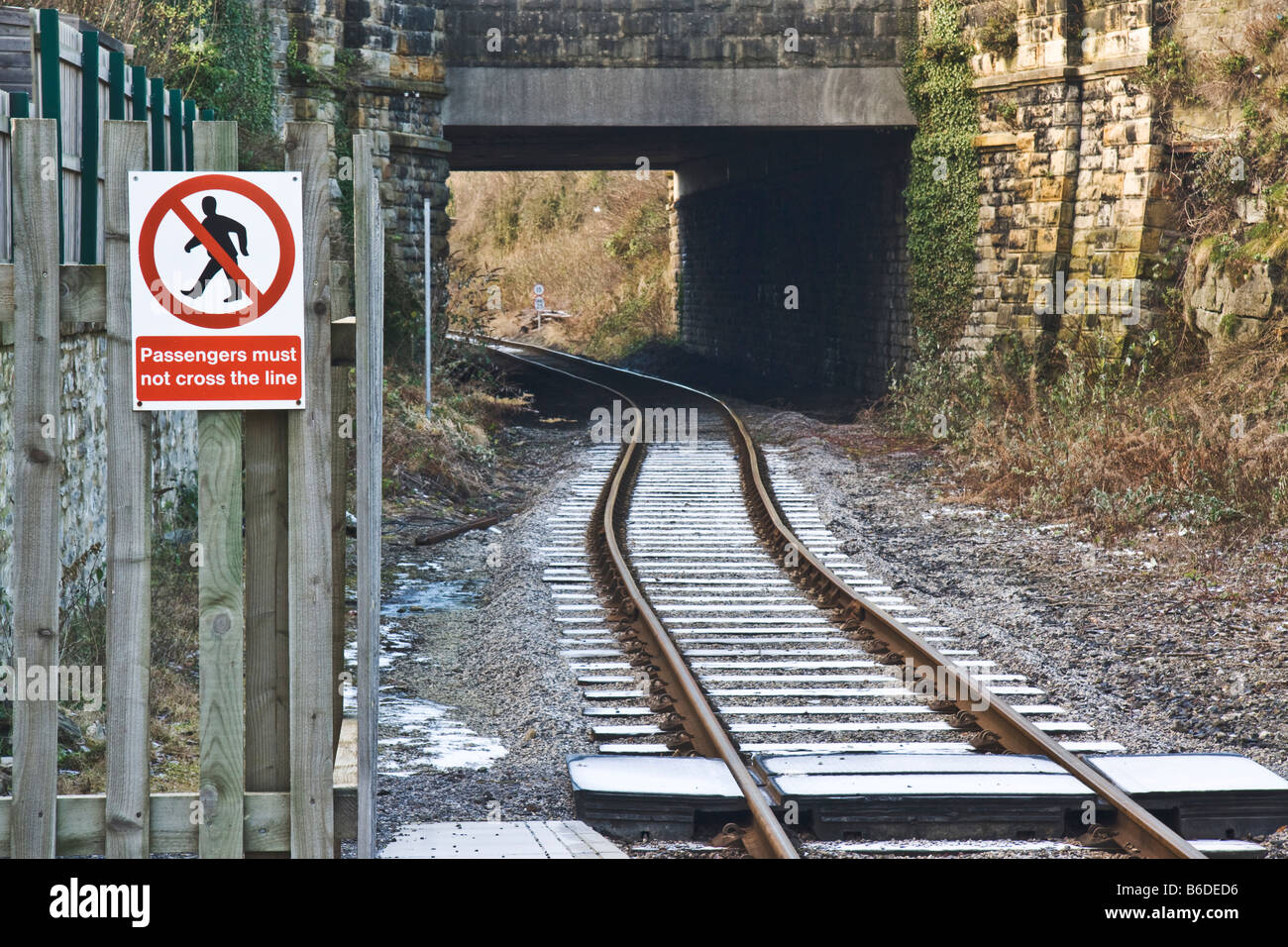 Railway line with warning signs to pedestrians not to venture onto the line. Stock Photo