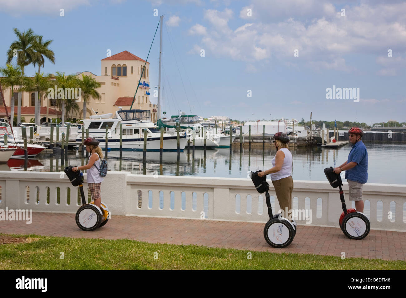 People riding Segways along Bradenton Florida marina Stock Photo