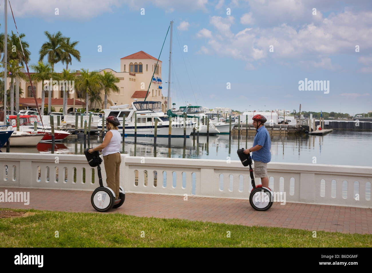 People riding Segways along Bradenton Florida marina Stock Photo