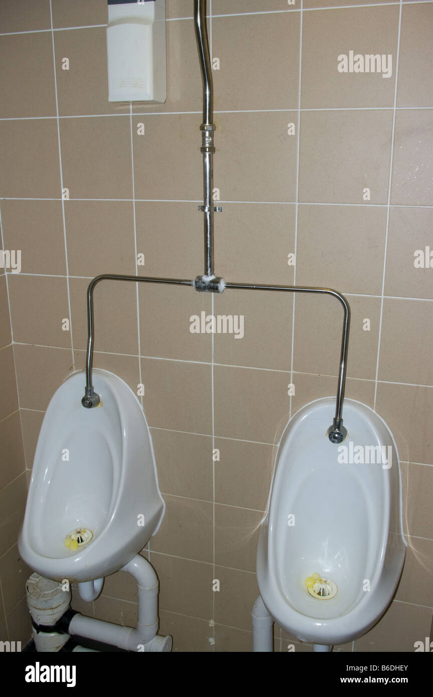 Dirty Urinals in Mens Public Toilets Stock Photo