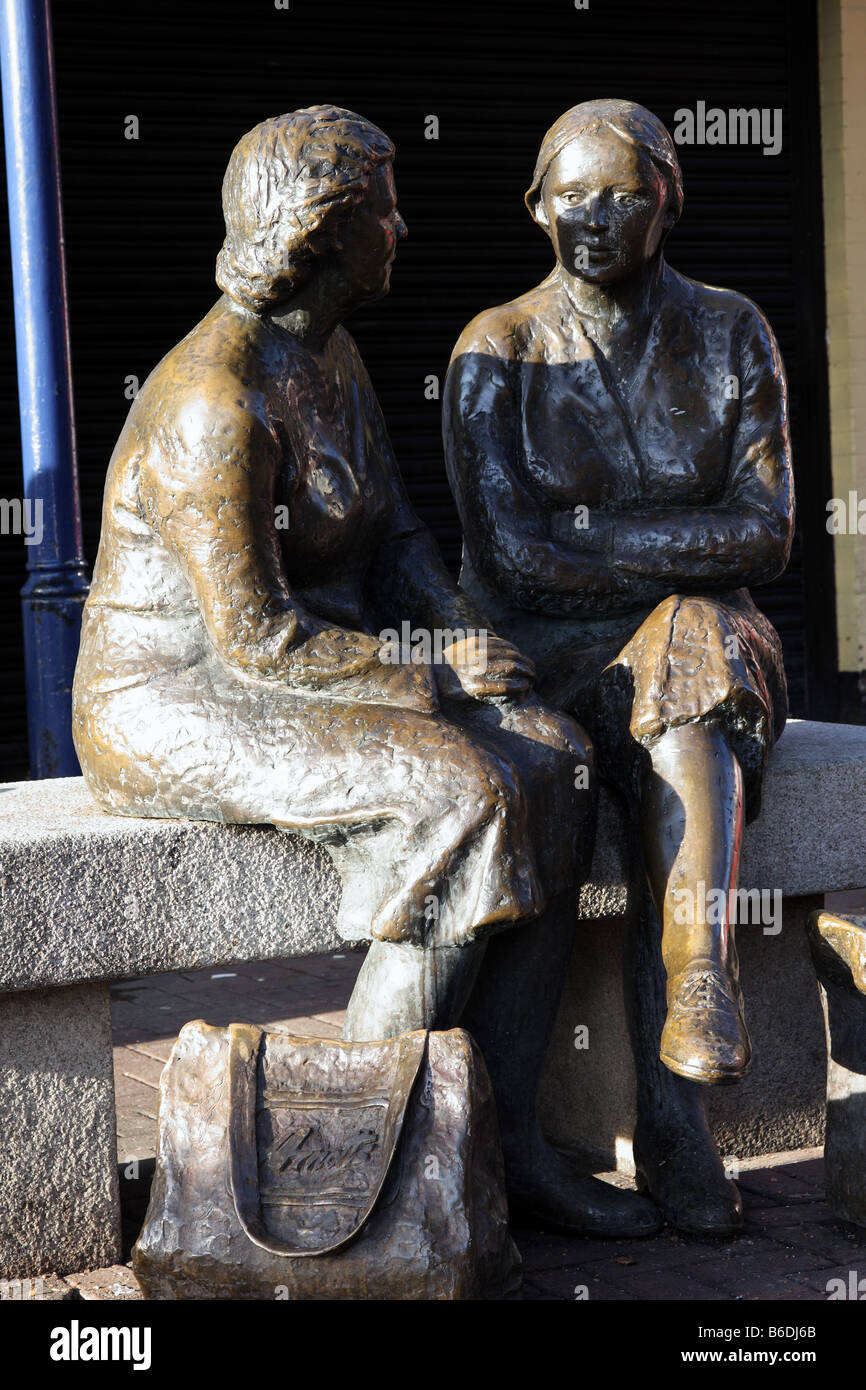 A statue of two ladies with shopping bags in the city of Dublin in the