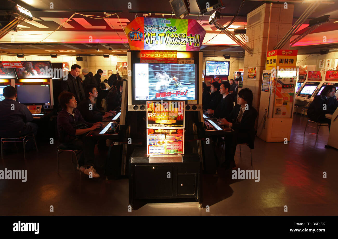 Amusement arcade with Japanese people playing computer games Stock Photo