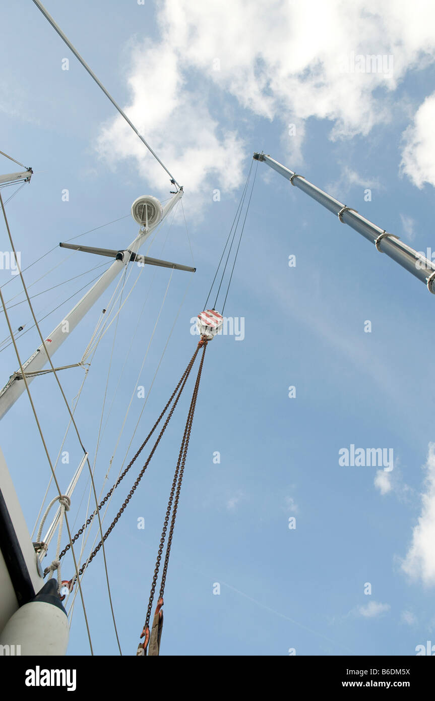 worms eye view of rigging, mast and jib of a yacht being prepared for lifting out Stock Photo