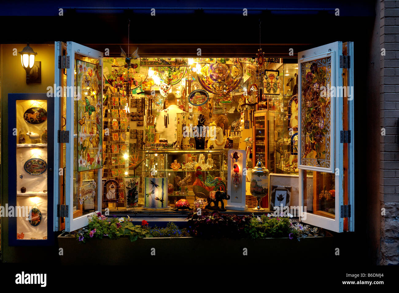 An open shop window full of coloured tourist souvenirs in Petit
