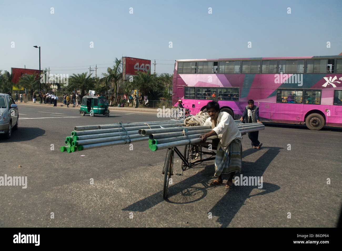 A man pushing a rickshaw cart in Dhaka Stock Photo