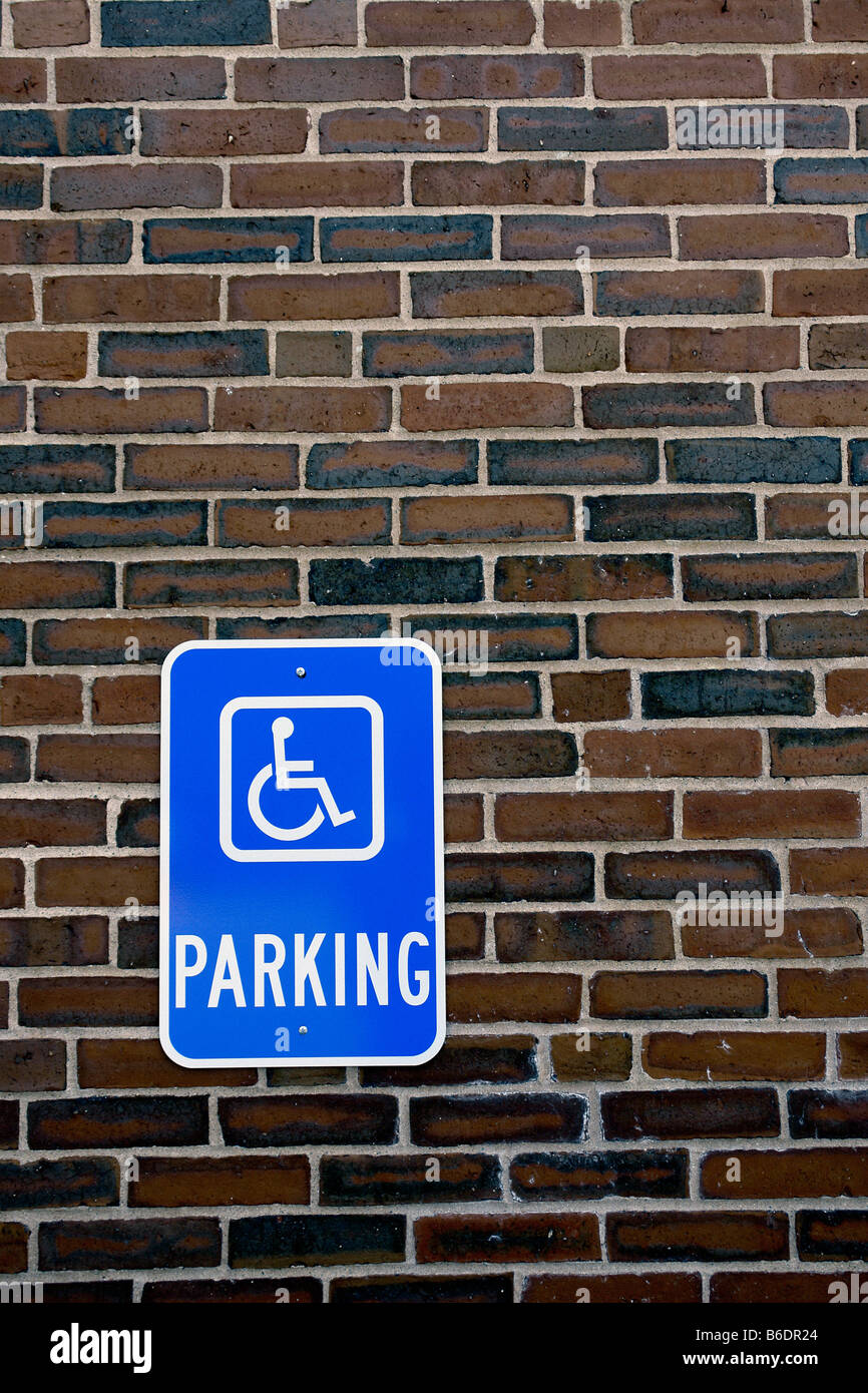 Urban Scene of a Handicapped Parking Sign on a Brick Wall in a Parking ...