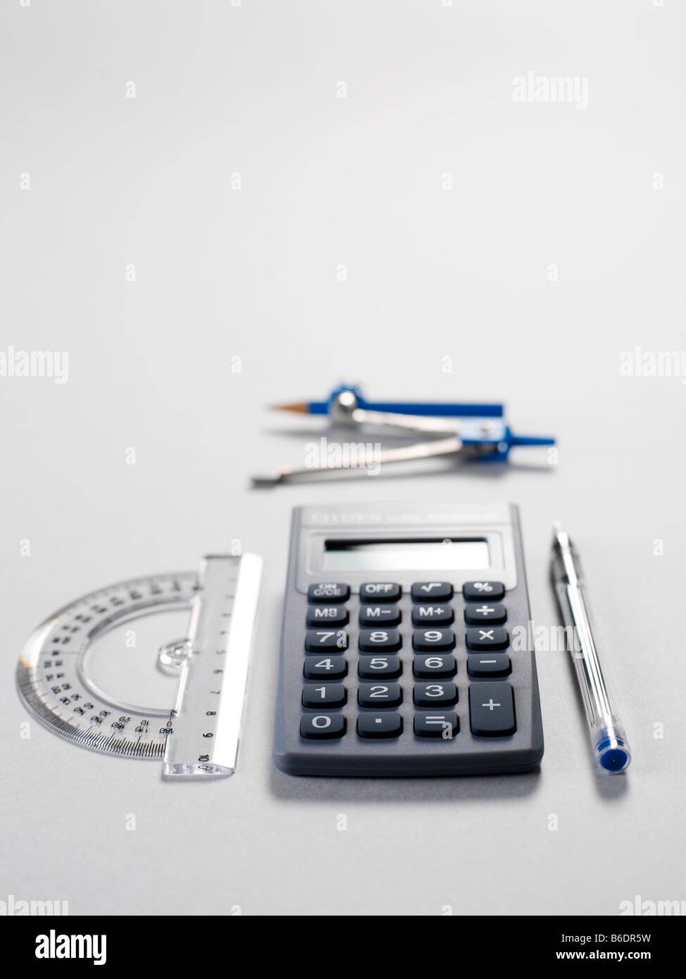 Mathematics equipment protractor (left) compass and pencil (centre top