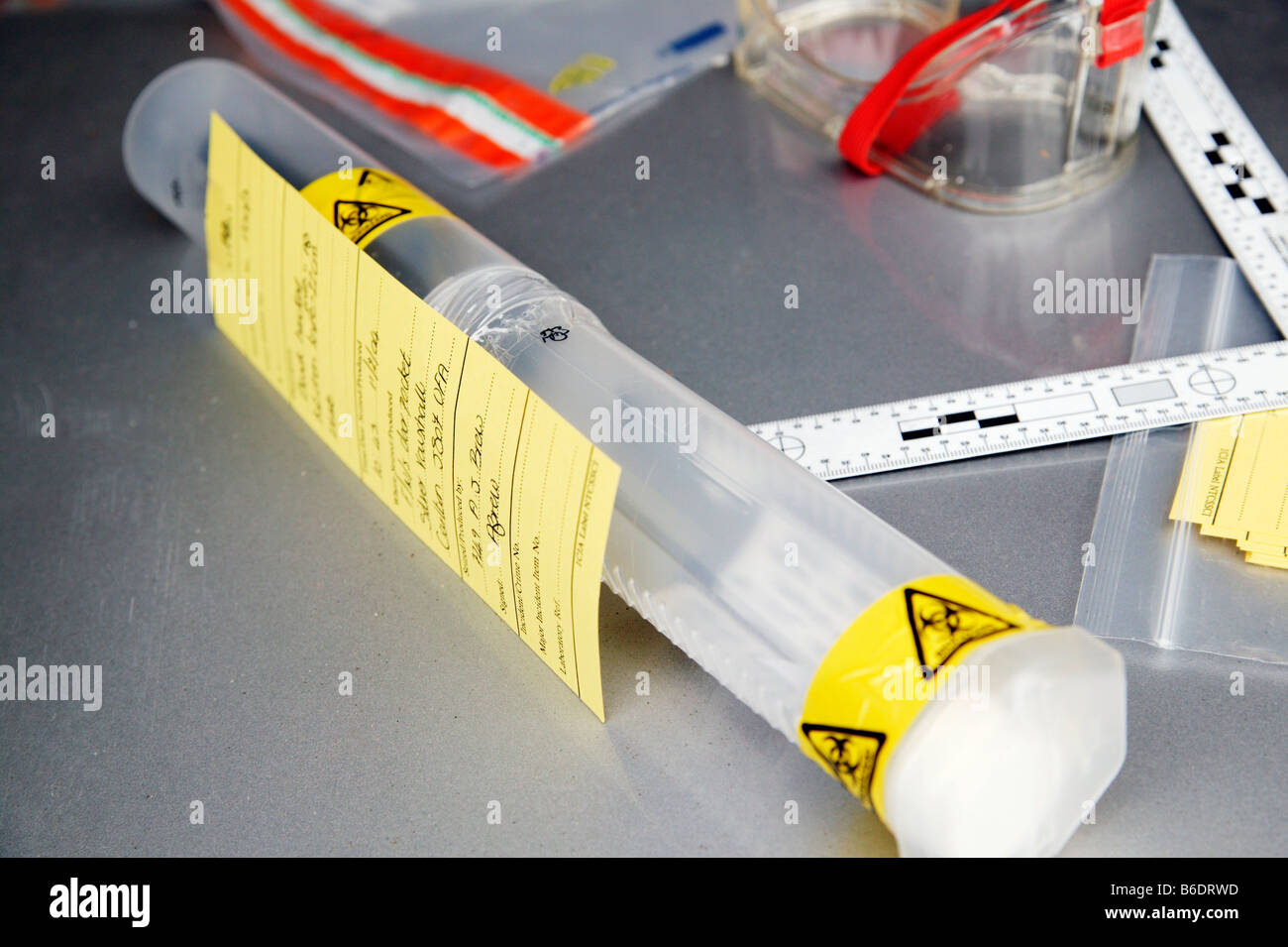 Forensic evidence. Container marked with biohazard warning tape