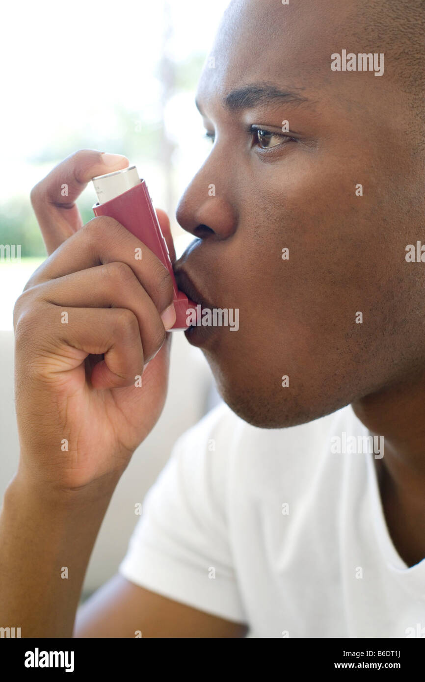 Man using an inhaler to treat an asthma attack Stock Photo Alamy