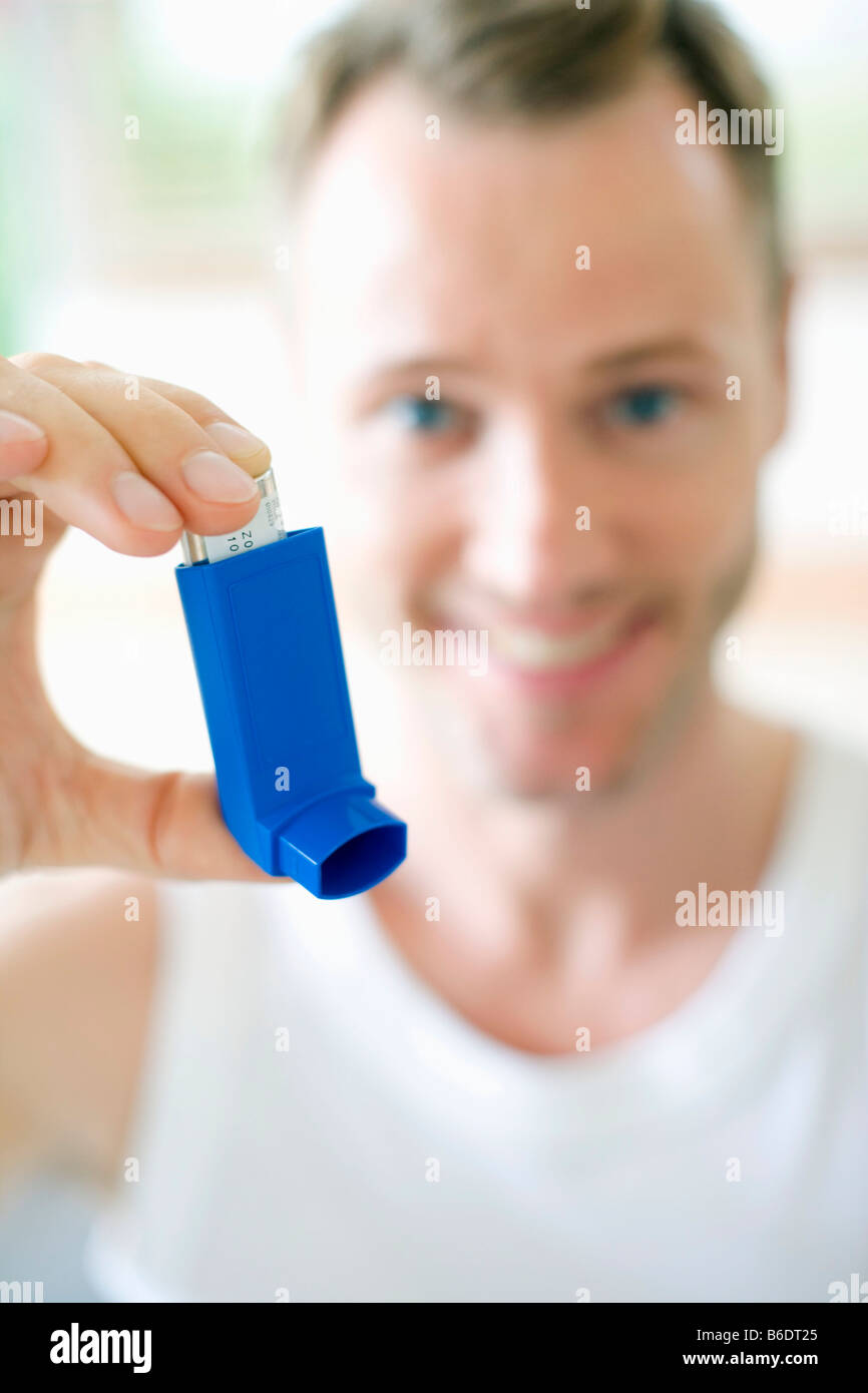 Man using an inhaler to treat an asthma attack Stock Photo Alamy