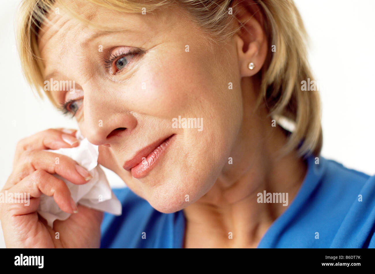 Sad woman, Middle aged woman crying and wiping the tears from her eyes. Stock Photo