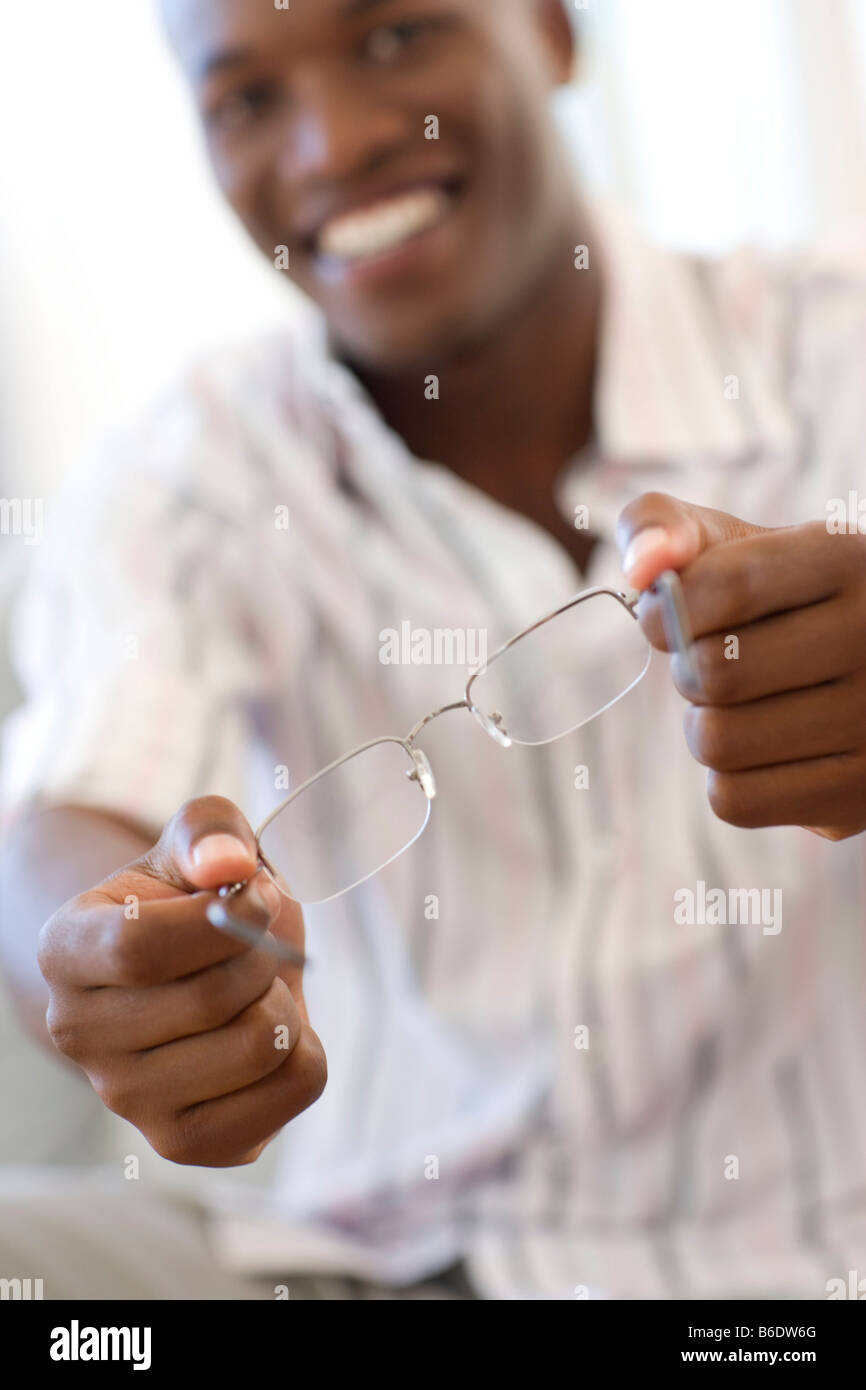 Man holding a pair of glasses. Stock Photo