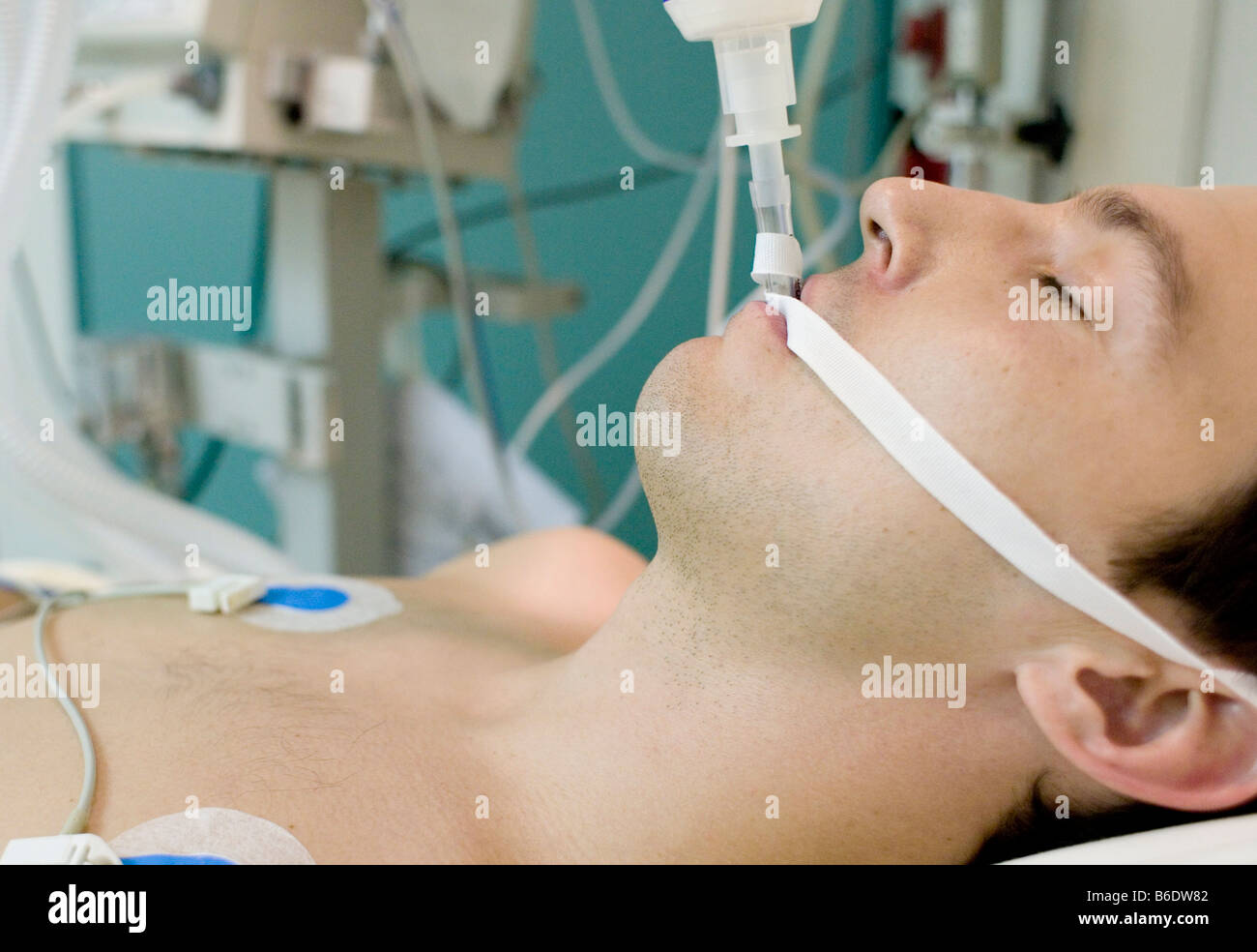 Intensive care patient. Unconscious man in the intensive care unit at a