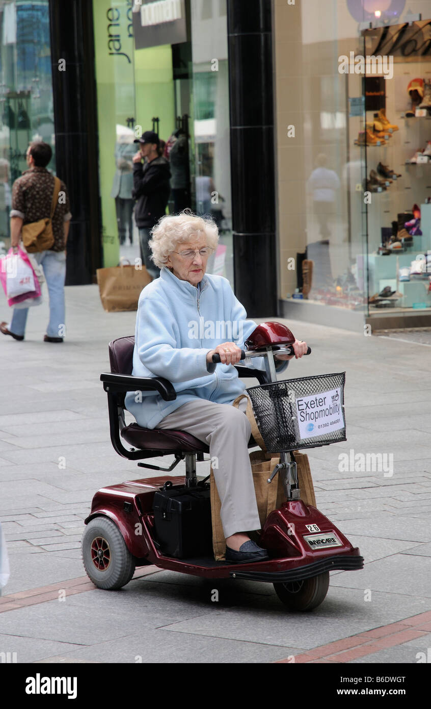 Elderly lady mobility electric scooter hires stock photography and