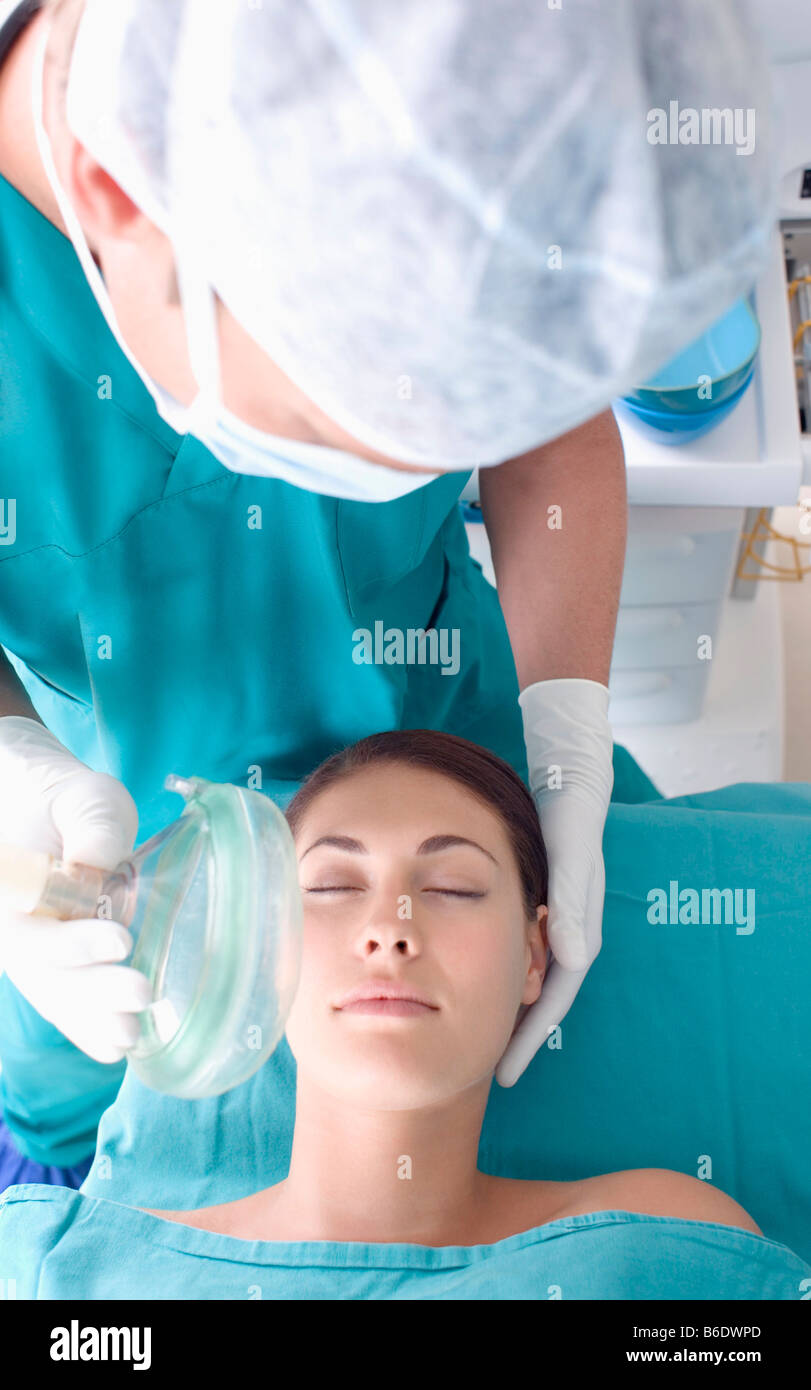 Anaesthesia. Anaesthetist administering gas to a patient. The gas is a
