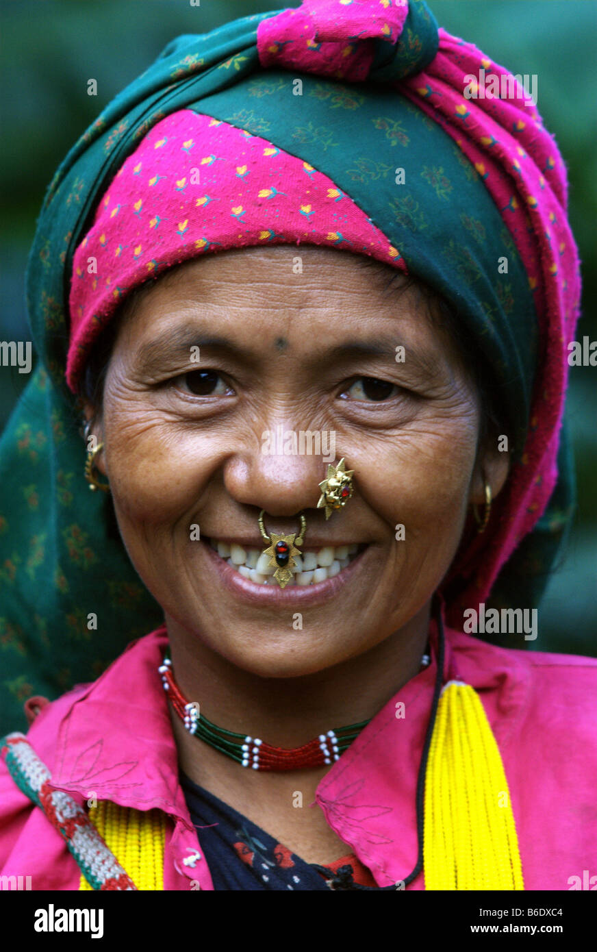 A woman of the Kami caste smiles in welcome, Tibling, Ganesh Himal, Nepal Stock Photo
