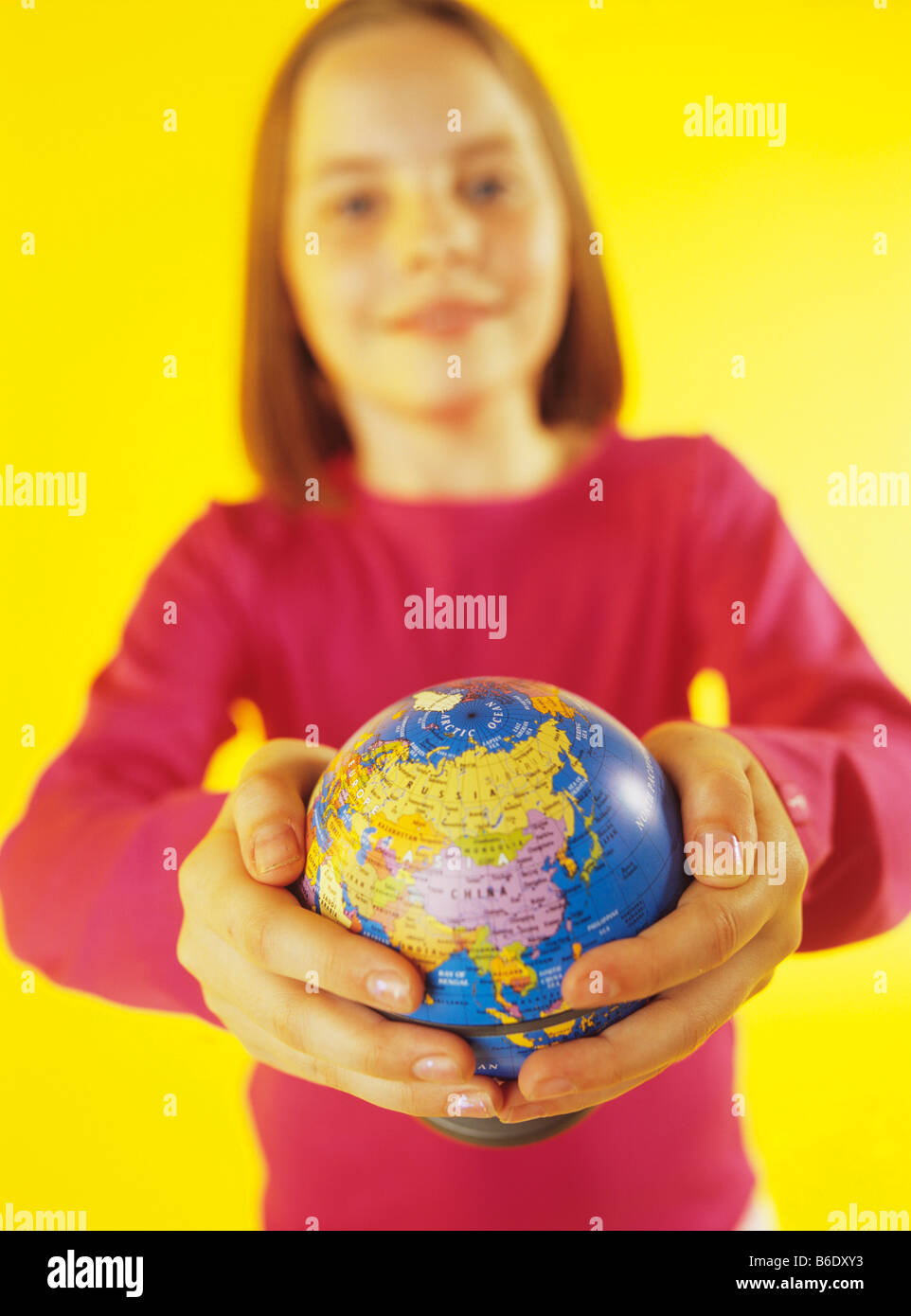 Holding a globe. 8yearold girl holding a globe in her hands Stock