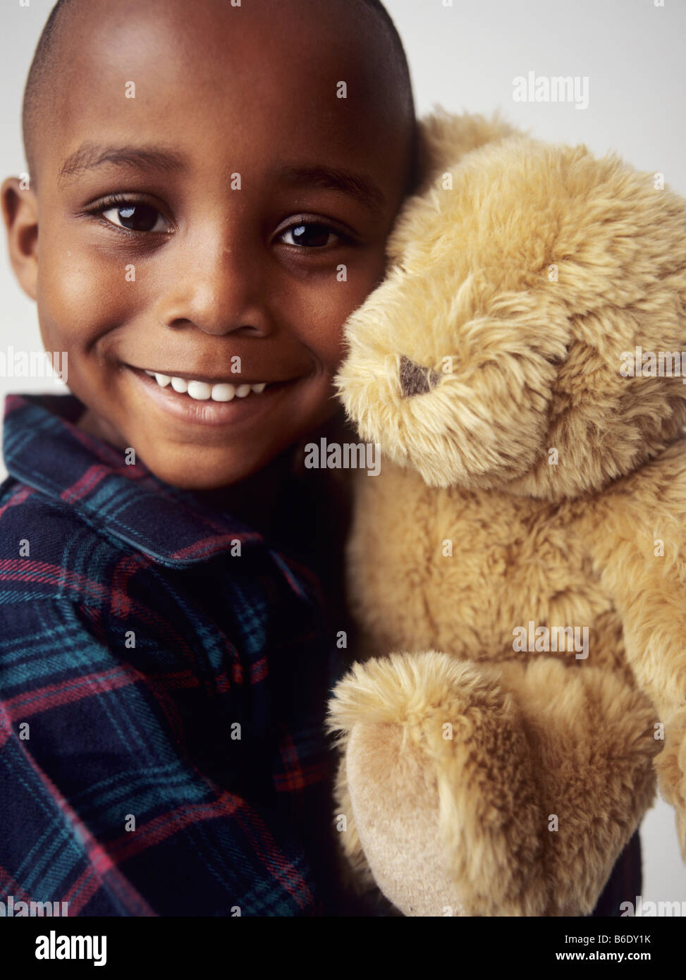Boy with teddy bear.4 year old boy smiling and holding a teddy bear ...
