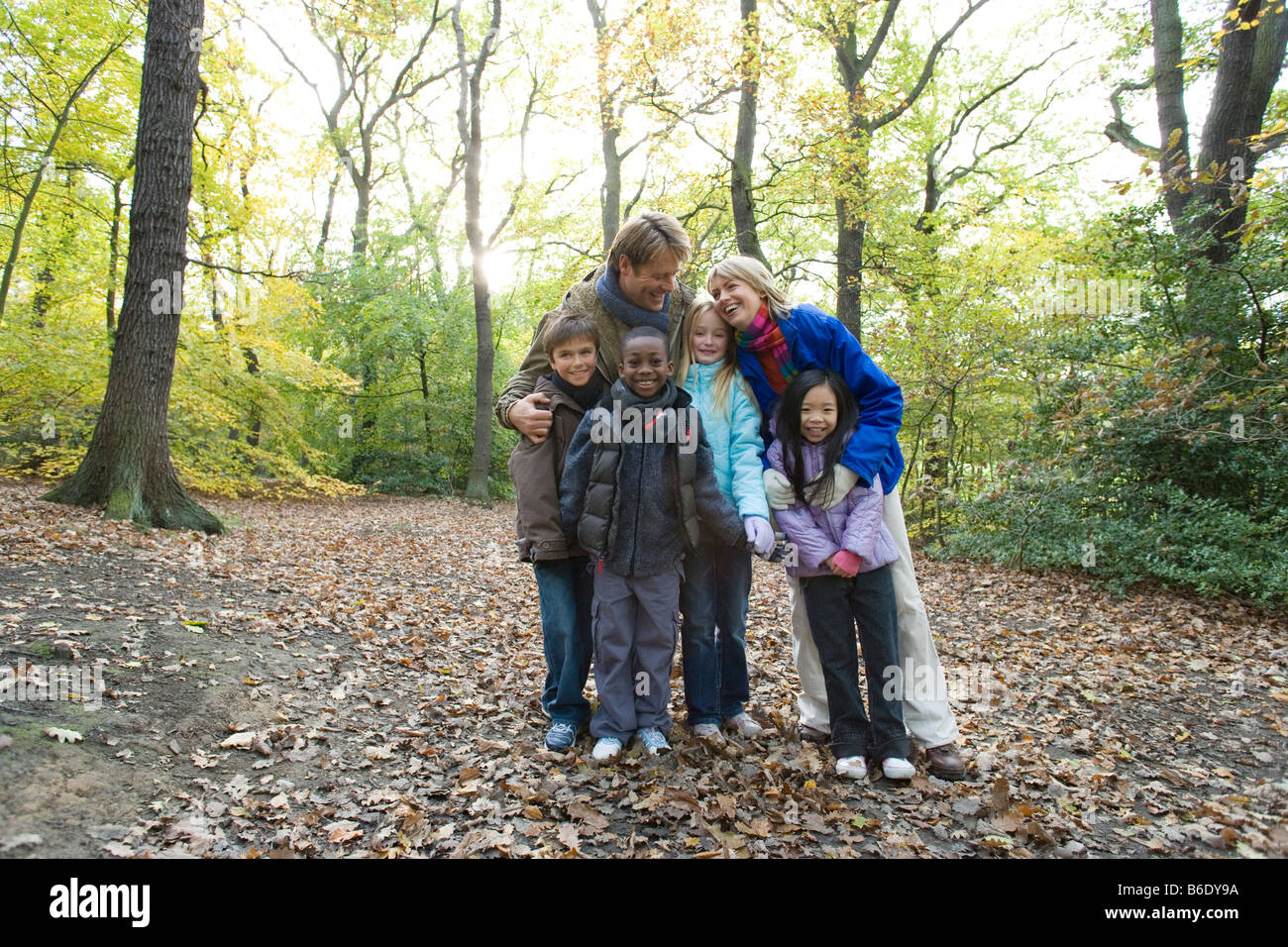 Parents and children in a wood in autumn. Stock Photo