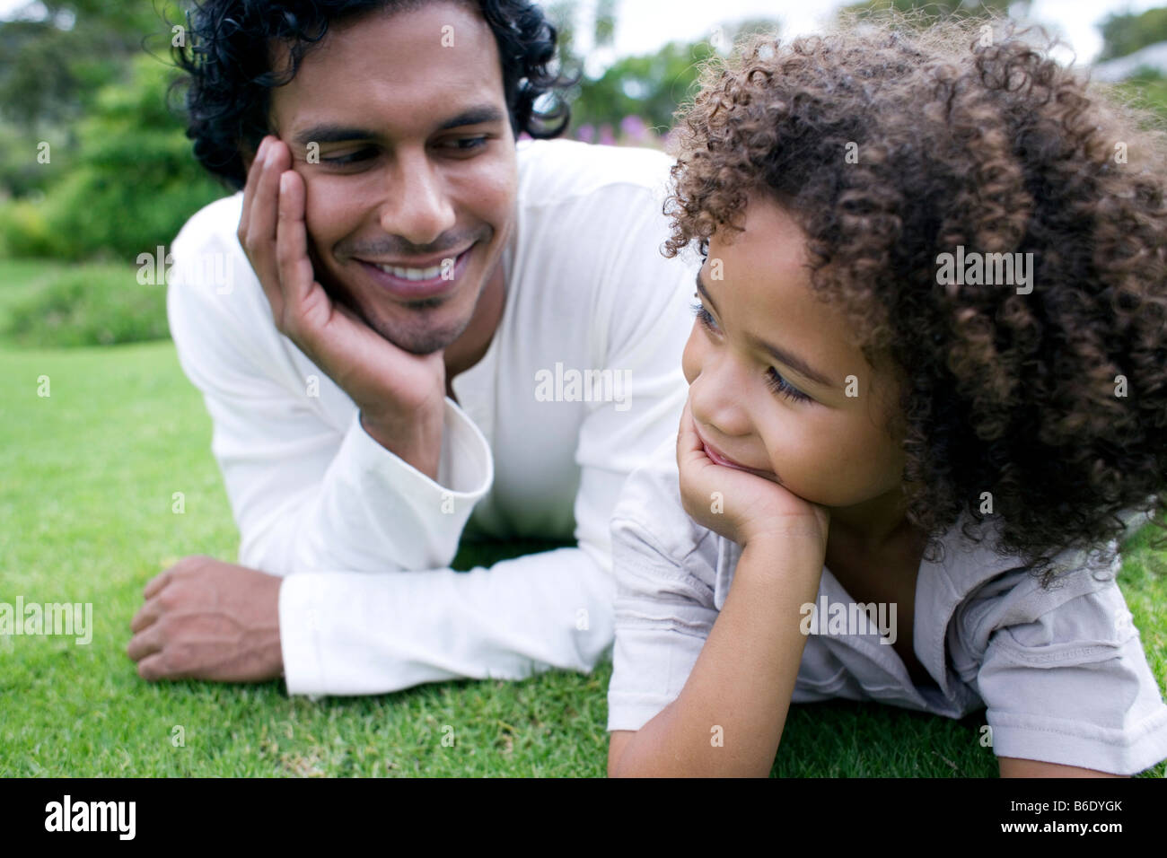 Father and son lying together on the grass Stock Photo - Alamy
